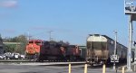 BNSF coal train passes the end of a CN grain train